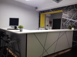 a kitchen with a counter with a computer on it at Esperanto Home in Katowice