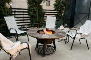 a fire pit on a patio with chairs and a table at loft apartments OLD MILL in Sarny