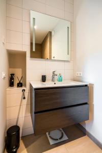 a bathroom with a sink and a mirror at Luxe appartement in haven Marina Kamperland - 2 badkamers in Kamperland