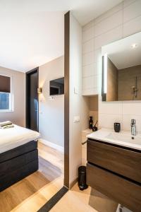 a bathroom with a sink and a bath tub at Luxe appartement in haven Marina Kamperland - 2 badkamers in Kamperland
