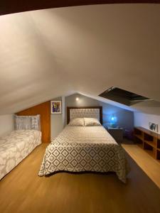 a bedroom with two beds in a attic at Barrosa House in Vila Praia de Âncora