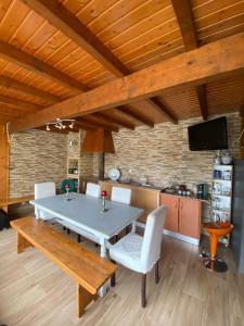 a dining room with a table and chairs and a tv at Barrosa House in Vila Praia de Âncora