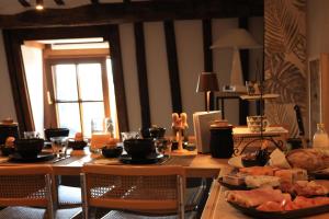 a dining room table with food on top of it at A la Caravelle in Chaineux