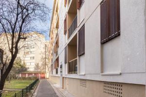 an empty street next to a building with windows at Le Cristol - joli T3 proche du Parc Dupeyroux in Créteil