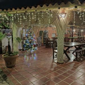 a christmas tree in the middle of a restaurant at Posada Las Ross in La Mira