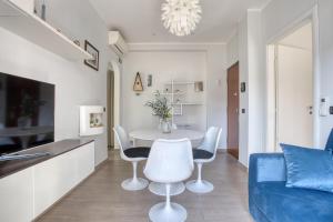 a dining room and living room with a table and chairs at ALTIDO Delightful flat with balcony in Milan