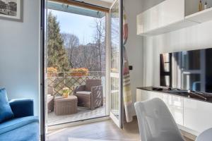 a living room with a glass door leading to a balcony at ALTIDO Delightful flat with balcony in Milan