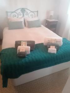 a bedroom with a bed with towels on it at Casa da Samouqueira in Rogil +45 photos