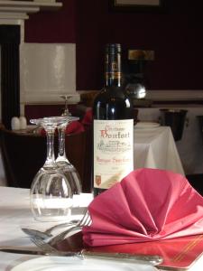 a bottle of wine sitting on top of a table at The Crown Hotel in Mundford
