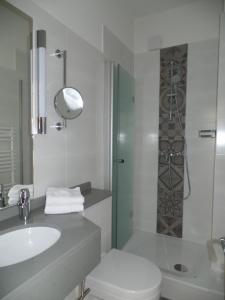 a bathroom with a toilet and a sink and a shower at Villa Silbermöwe in Wyk auf Föhr +38 photos