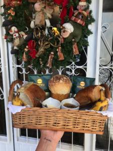 格拉馬杜的住宿－St. Virginia’s，持有面包和糕点篮的人