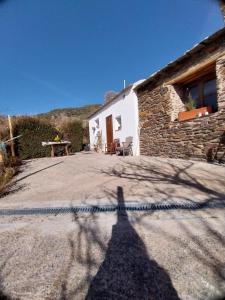 a shadow of a person standing in front of a house at Los Castaños, Vivienda Rural, Capileira in Capileira