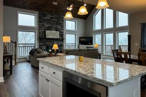 a kitchen and living room with a large counter top at Shady Pines in Gatlinburg
