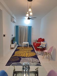 a living room with a rug on the floor at İmpiana Homestay near PUTRAJAYA, CYBERJAYA, Musliem Only,WIFI,Netflix in Kampung Dengkil