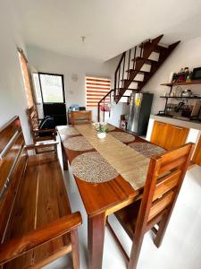 a kitchen with a long wooden table with chairs at Palawan two bedroom home in puerto princesa city in Puerto Princesa City