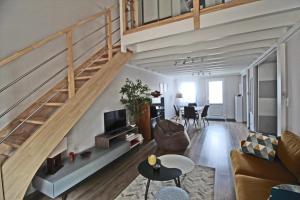 a living room with a loft with a staircase at L'escapade in Limoges