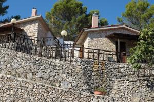 a stone wall in front of a house at Agriturismo Monte Sacro in Mattinata