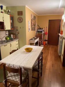 a kitchen with a table and some chairs and a table and a kitchen at Hotel Sole in Prato Nevoso