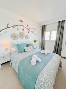 a bedroom with a bed with towels on it at Beautiful sea views apartment Pool & Beach in Torremolinos