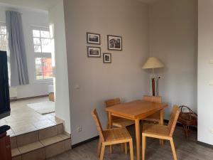 a dining room with a table and chairs and a television at Schloss Spiegelberg in Neustadt
