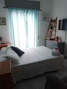 a bedroom with a large bed with a large window at Bella Vista in Almería