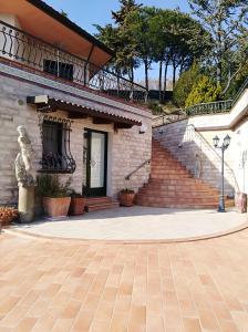 a brick building with a staircase next to a sidewalk at B&B Villa Diana in Ancona