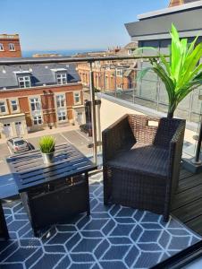 a patio with a table and a chair on a balcony at The Penthouse Margate, Balconies, Sea View, Gated Parking, Air Con! in Margate