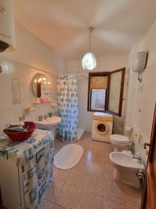 a bathroom with a toilet sink and a washing machine at Villa Regina in Fort Village