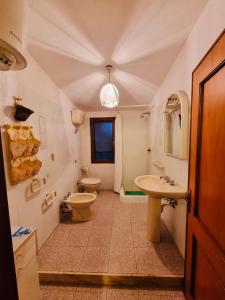 a bathroom with two toilets and a sink and a mirror at Villa Regina in Fort Village