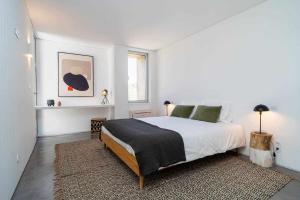 a white bedroom with a large bed and a rug at Acushla Golden House Douro in Lodões