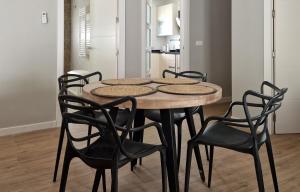 a dining room table and chairs in a room at Sunset Apartment in Huelva