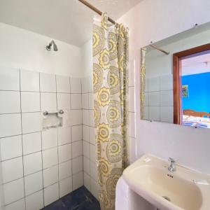 a bathroom with a sink and a mirror at Hostal Chasqui in Otavalo