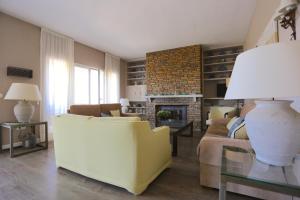 a living room with a couch and a fireplace at VILLA DEL MAR 'Boutique Beach-House' 11PAX in Rincón de la Victoria