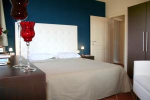 Ein Bett oder Betten in einem Zimmer der Unterkunft Il Poggiolo Delle Rose Bed&Breakfast