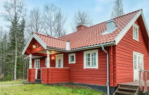 a red house with a red roof at 5 Bedroom Awesome Home In Kopparberg in Ställdalen