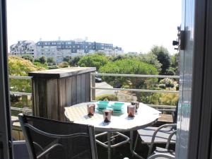 a table and chairs on a balcony with a view at Appartement La Rochelle, 1 pièce, 4 personnes - FR-1-246-268 in La Rochelle