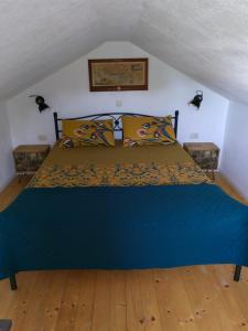 a bedroom with a blue bed with two night stands at House for rent Didova kuća in Makarska