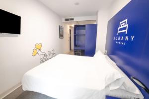 Posteľ alebo postele v izbe v ubytovaní Hostal Albany