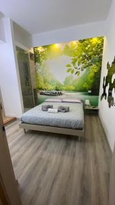 a bedroom with a bed with a painting on the wall at Petros rooms&apartments in Salerno