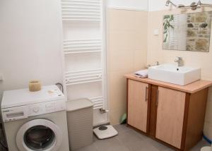 a bathroom with a washing machine and a sink at Ioanna 's Place in Sívas