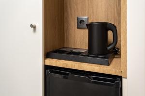 a coffee pot sitting on top of a stove in a kitchen at Empire Marquês Hotel in Lisbon