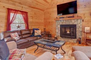 a living room with a couch and a fireplace at Relax & Unwind Hot-Tub 6 seater, Fire-Pit, Master King Bed, Near Wineries, Resort Amenities in Ellijay