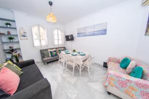 a living room with a table and a couch at MI RETIRO SEVILLANO in Seville