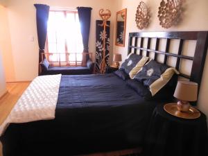 a bedroom with a large bed and a window at J&B Lodge in Underberg