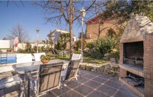 a patio with a table and a brick fireplace at El Pino Cajar Granada in Cájar