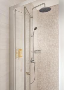 a shower with a glass door in a bathroom at Empire Marquês Hotel in Lisbon