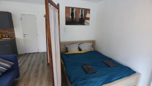 a small bed in a room with a mirror at Studio 200 meters from Central station in Antwerp
