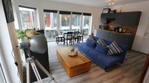 a living room with a blue couch and a table at Studio 200 meters from Central station in Antwerp