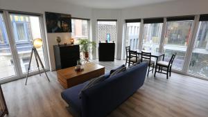 a living room with a blue couch and a table at Studio 200 meters from Central station in Antwerp