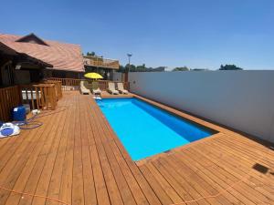 a swimming pool on top of a wooden deck at Vila kasa vali in Zekharya